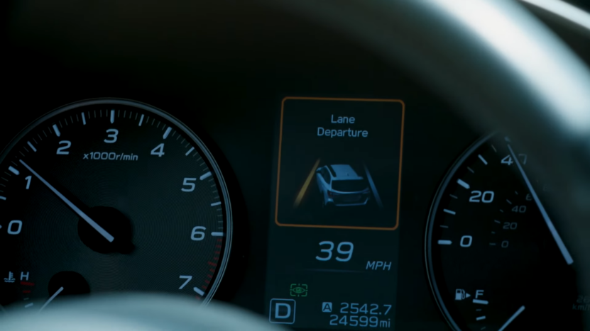 A Close-Up View of A BMW's Digital Dashboard Displaying the Lane Departure Warning System Active at 39 MPH