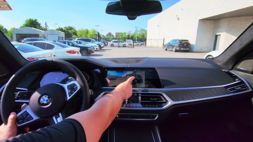 Driver's Perspective Inside a BMW Using the Touchscreen Display for Parking Assistance in A Car Lot