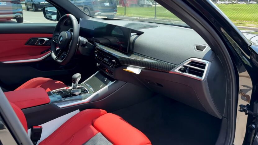 Interior View of The 2025 BMW M3 Showing the Driver's Cockpit with A Modern Steering Wheel, Red Leather Seats, and A High-Tech Dashboard