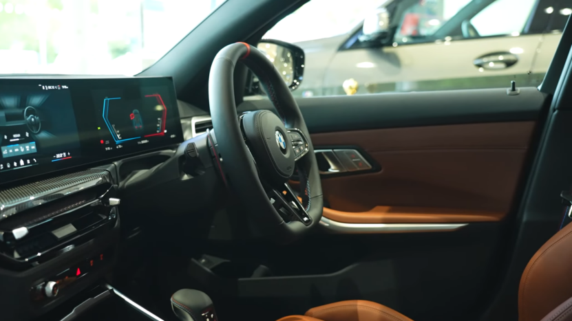 Interior View of The 2025 BMW M3 Showcasing the Steering Wheel and A High-Resolution Infotainment System with Advanced Connectivity Features