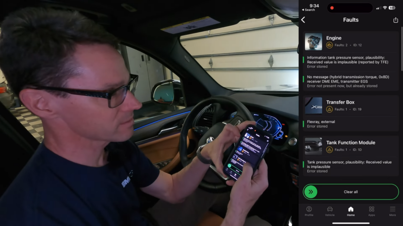 Technician Using an Obd-Ii Scanner App on A Smartphone to Diagnose Faults in A BMW