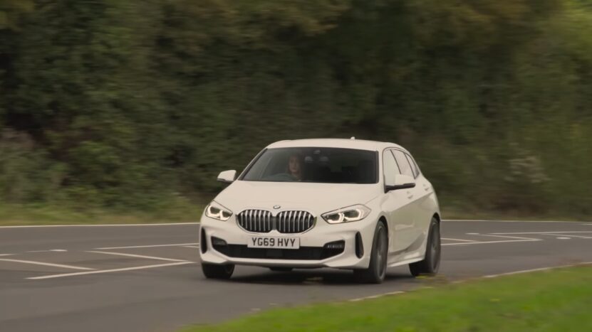 Front View of A White BMW 1 Series Driving on A Road