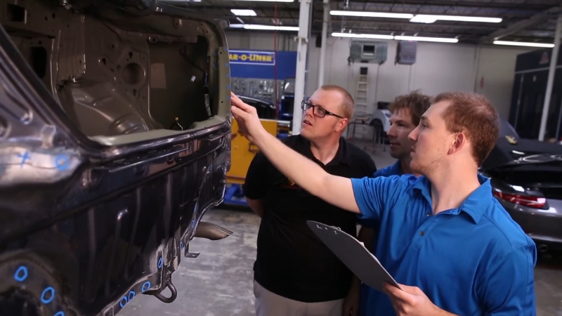 Technicians Inspecting a Vehicle in A BMW-Approved Repair Shop