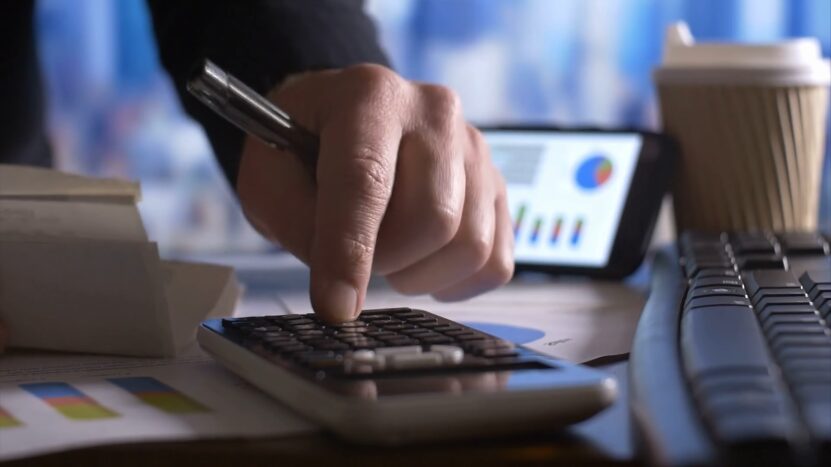 A Person Using a Calculator to Review Car Financing Options