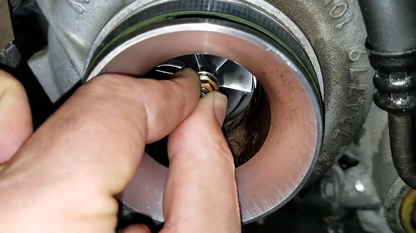 A Close-Up of A BMW N47 and B47 Turbocharger Being Checked for Damage