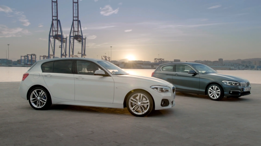 Two BMW 1 Series Cars Parked Near a Waterfront at Sunset