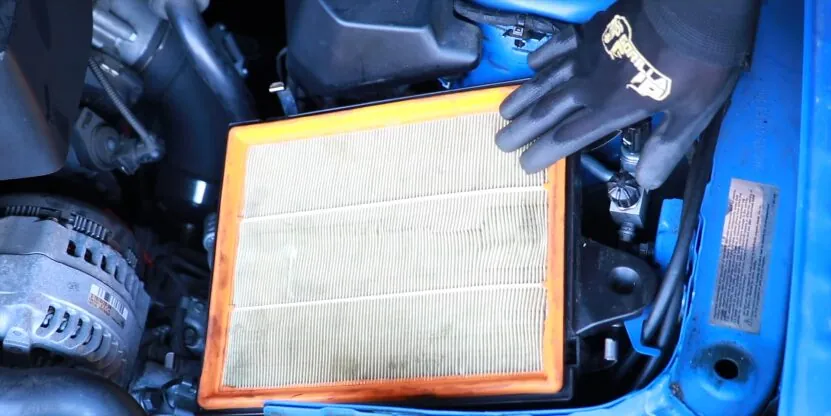 Mechanic Replacing a BMW Air Filter with A High-Performance Filter