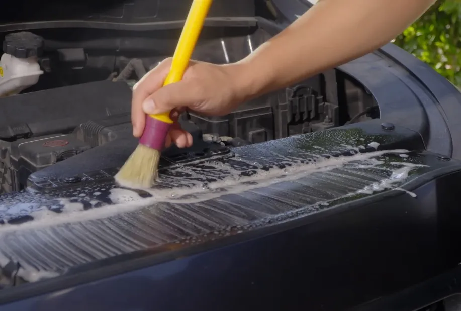 Guy cleans engine with brush