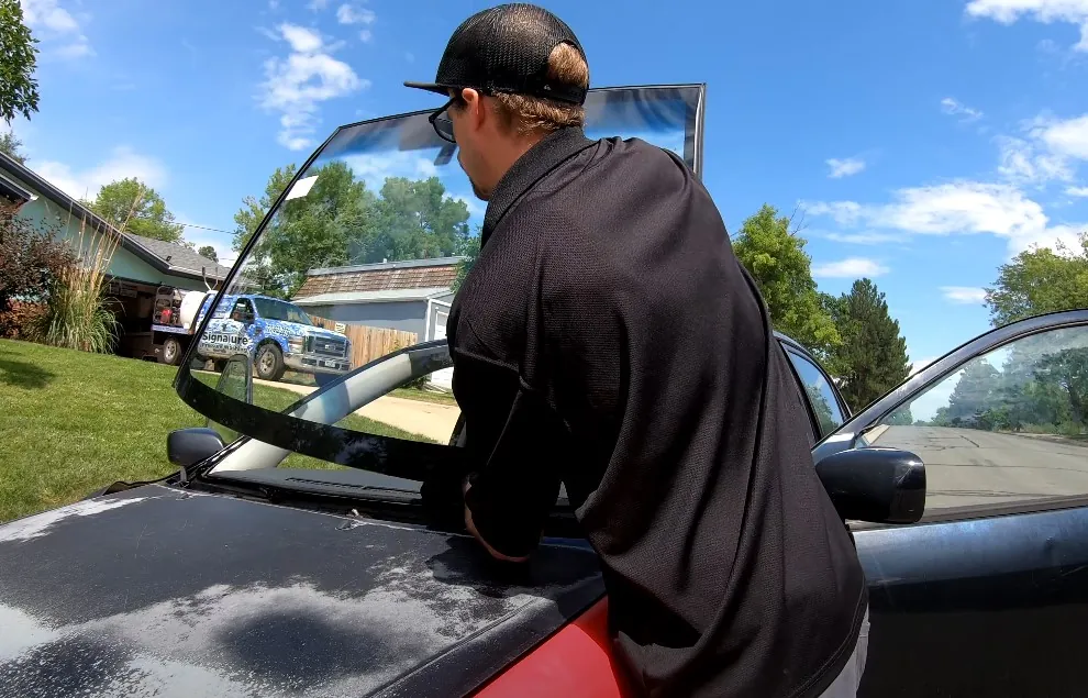 Professional replacing car windshield