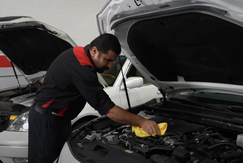 Professional cleaning car's engine bay with cloth