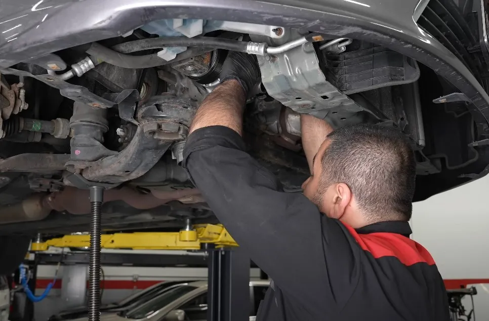 Mechanic repairs car's AC