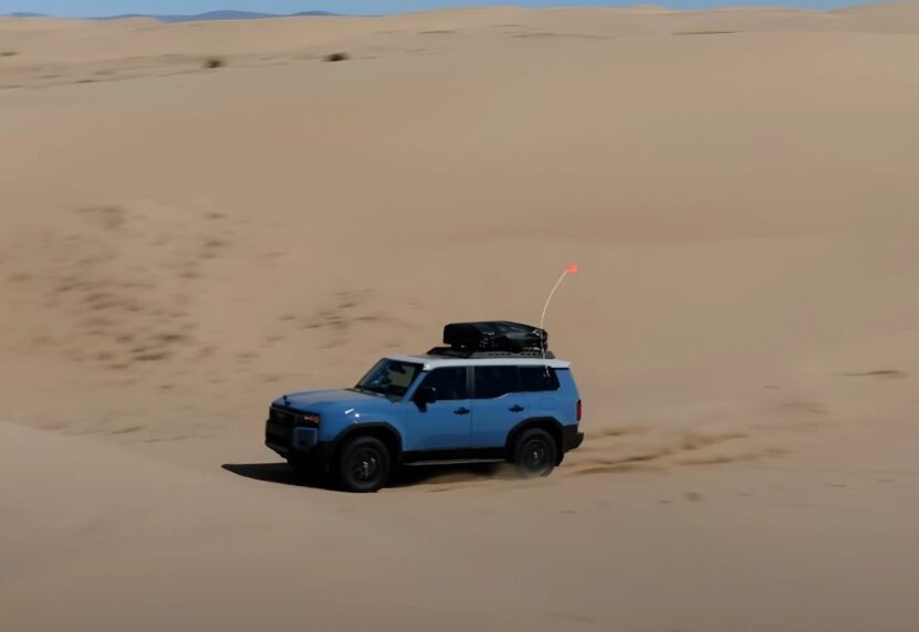 Blue Toyota Land Cruiser in sandy desert