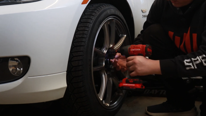 Person Installing Lightweight Wheels on A BMW