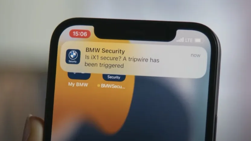 Phone Showing a BMW Security Alert for A Triggered Tripwire, Highlighting GPS Trackers' Role in Theft Detection