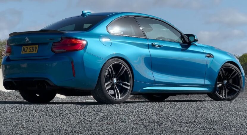 Light blue BMW M2 F87 car on the asphalt road