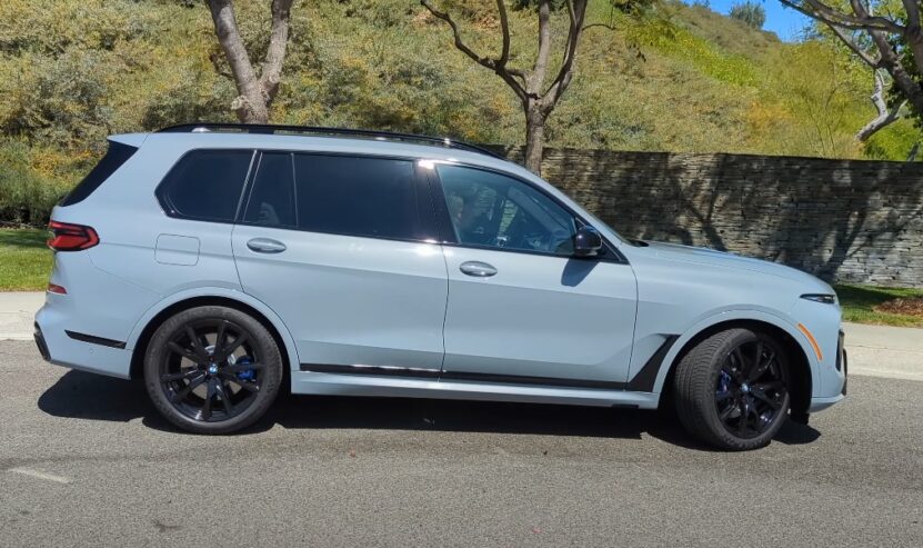 BMW X7 parked on the asphalt road