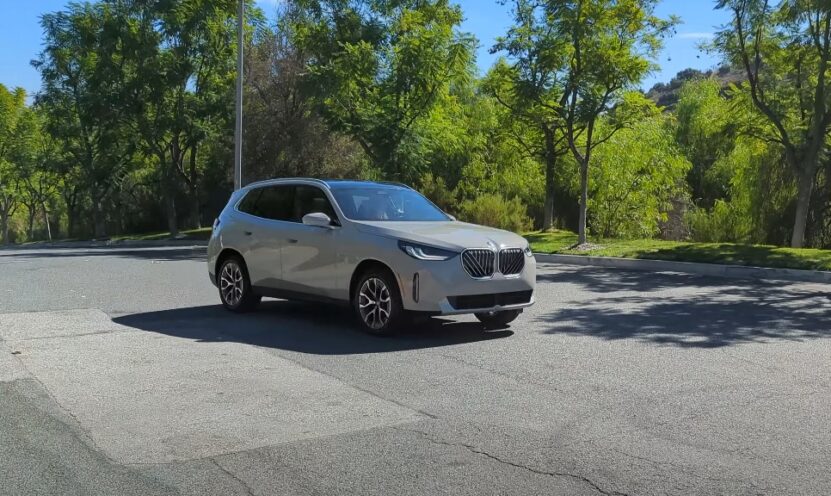 BMW X3 SUV cruising down the street