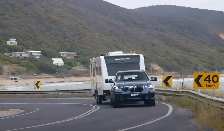 BMW towing a caravan on a highway