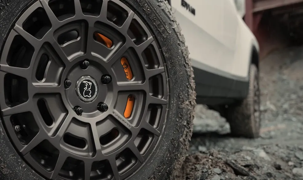 Close up photo of a black wheel on Rivian R1T truck