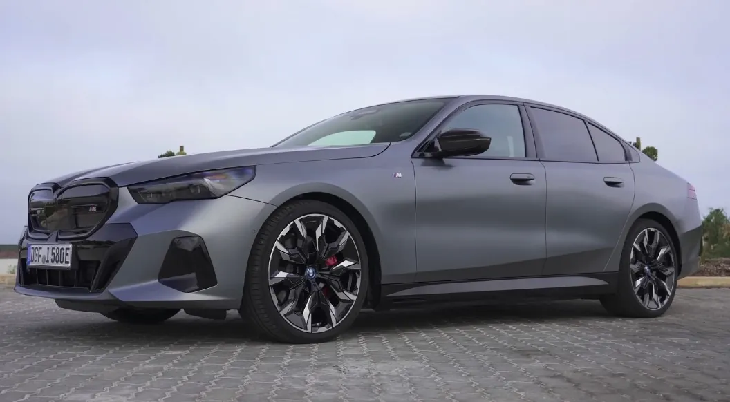 BMW 5 Series parked on asphalt road