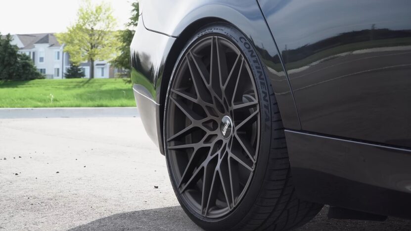 Close-up of a black sports car's rear wheel